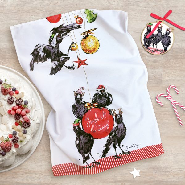The festive magpies tea-towel 'in situ', next to a yummy looking pavlova and a Festive Magpies Wooden Ornament