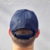 A BirdLife Australia bestie wearing a navy cap. The back of the cap, displaying the adjustable velcro strap, is shown.