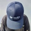 A BirdLife Australia bestie wearing a navy cap. The front and top of the cap is shown.