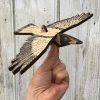 An assembled wooden mobile of an Australian Magpie, held in the hand.